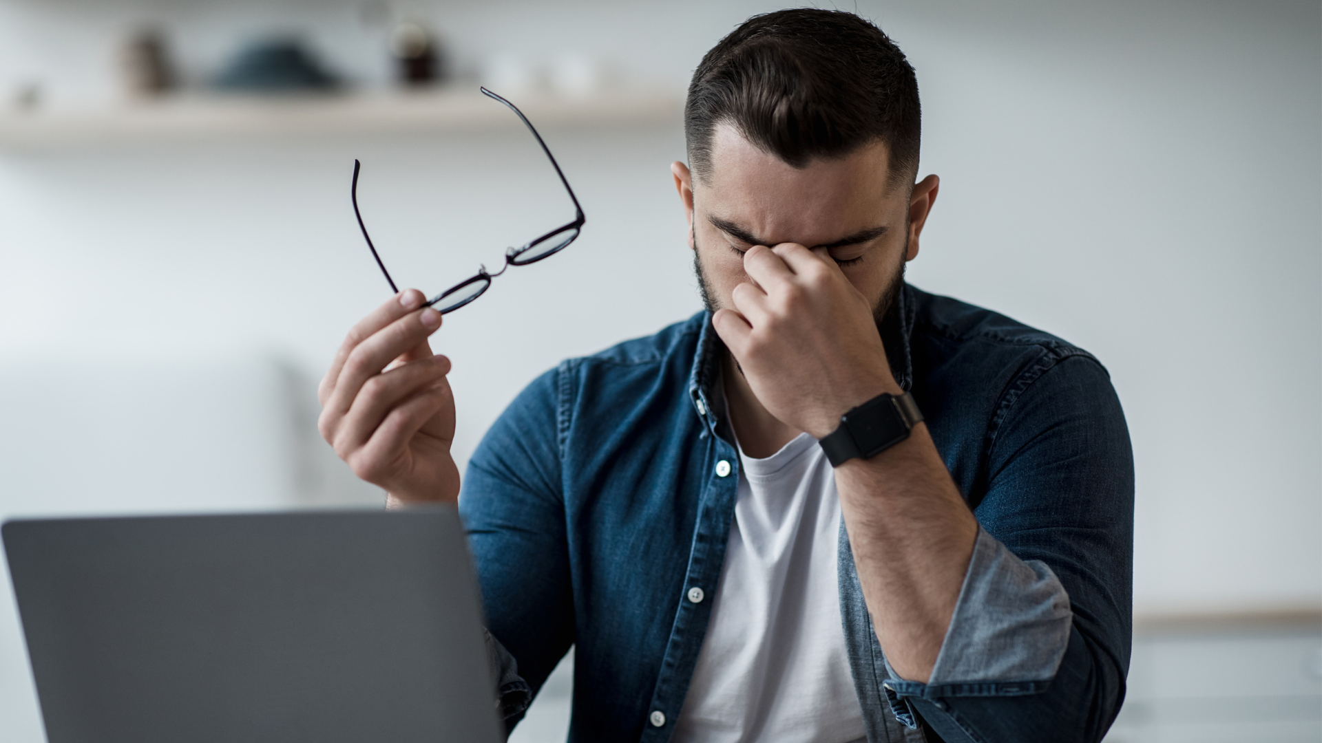 man at laptop looking stressed